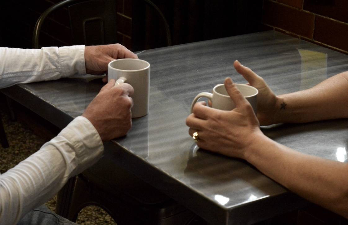 Two people talking over a cup of tea